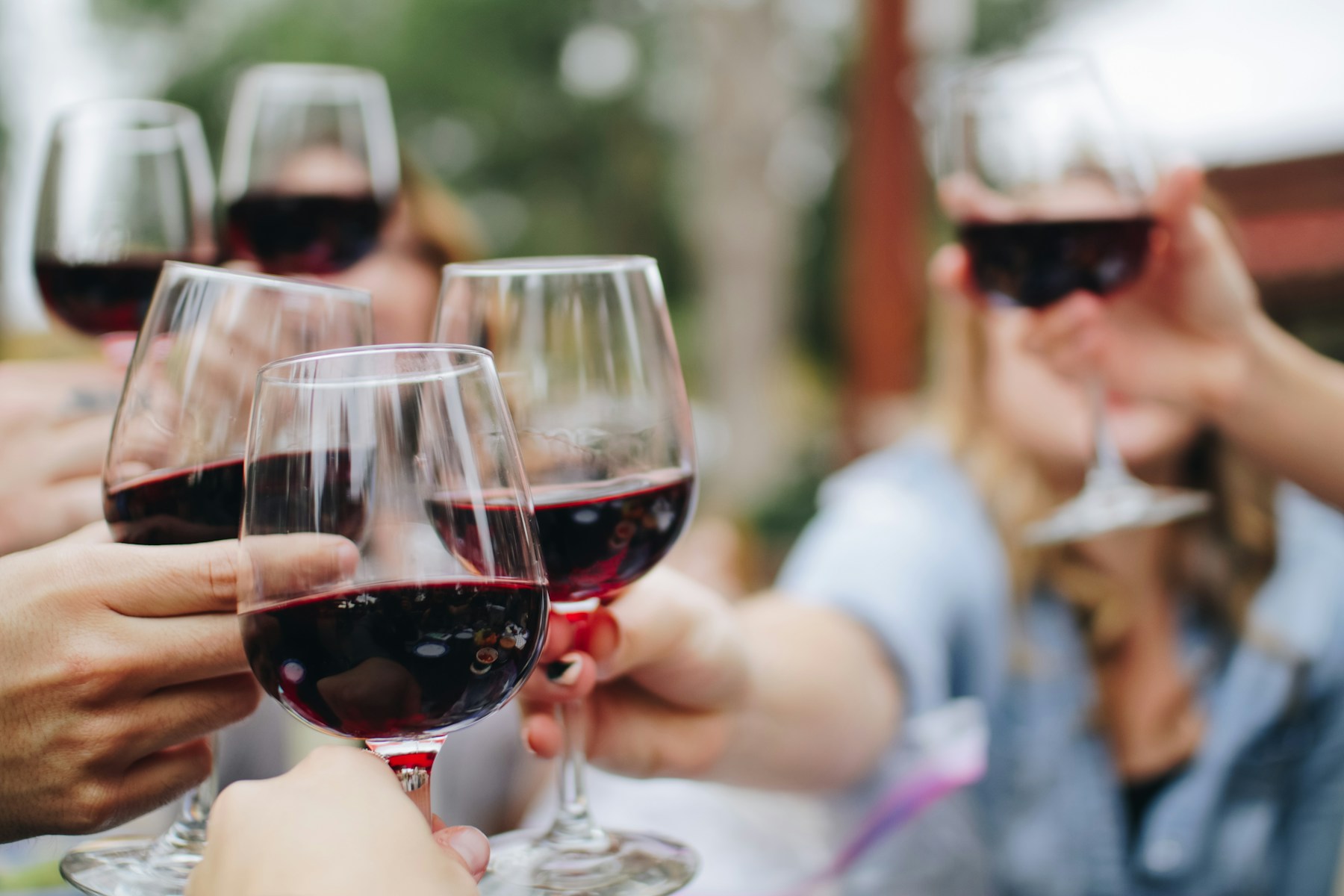 Friends raising glasses of red wine